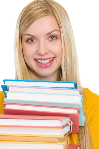 Menina estudante feliz segurando pilha de livros — Fotografia de Stock