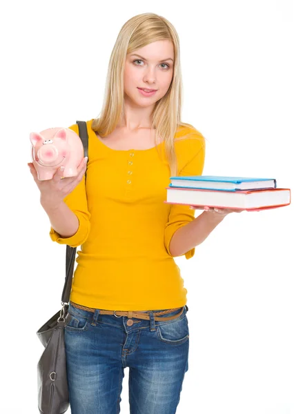 Studente ragazza mostrando libri e salvadanaio — Foto Stock