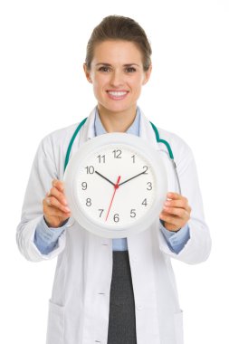 Smiling medical doctor woman showing clock clipart