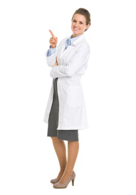 Full length portrait of woman in white robe pointing on copy spa clipart