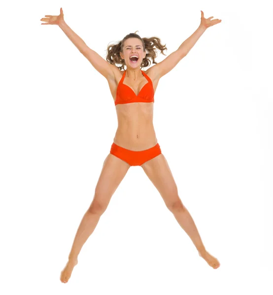 Szczęśliwa młoda kobieta w strój kąpielowy skoki — Zdjęcie stockowe
