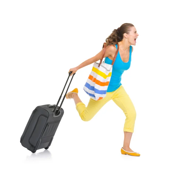 Concerned young tourist woman with wheel bag rushing — Stock Photo, Image