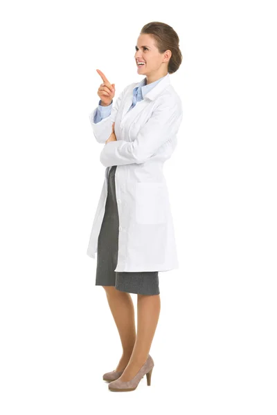 Full length portrait of woman in white robe pointing on copy spa — Stock Photo, Image