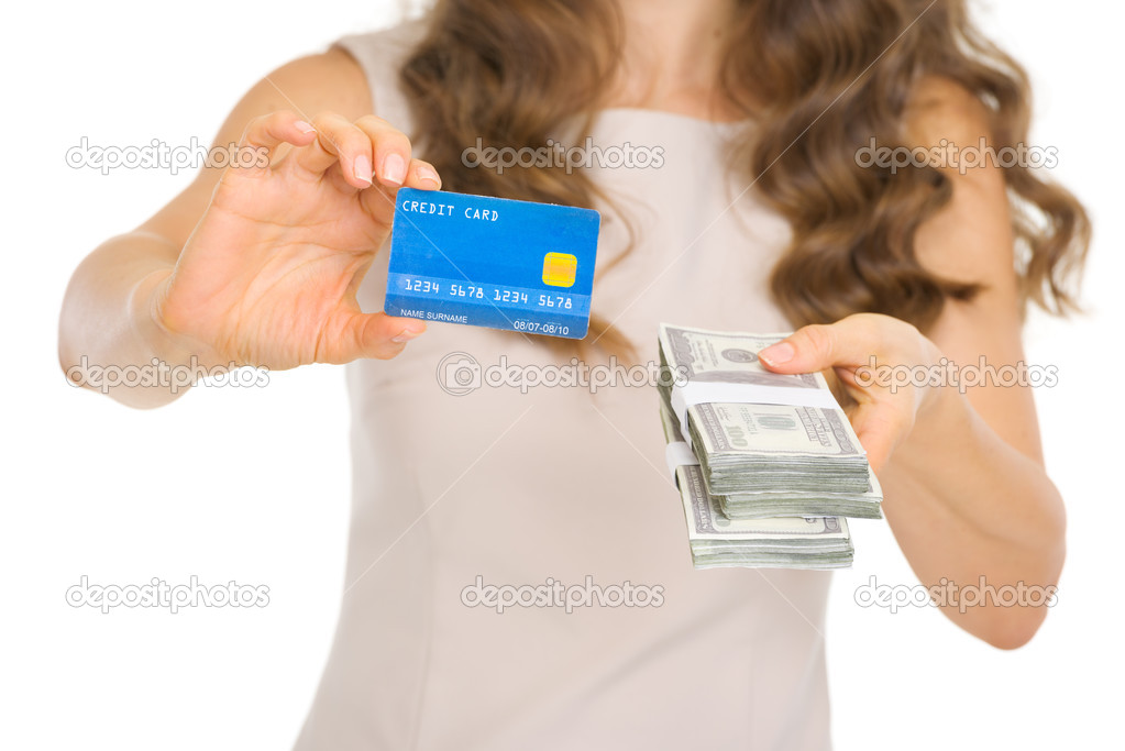 Closeup on woman showing credit card and money packs