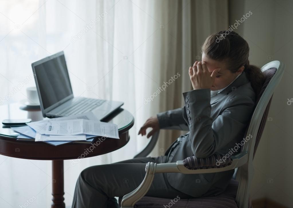 Stressed business woman working in hotel room