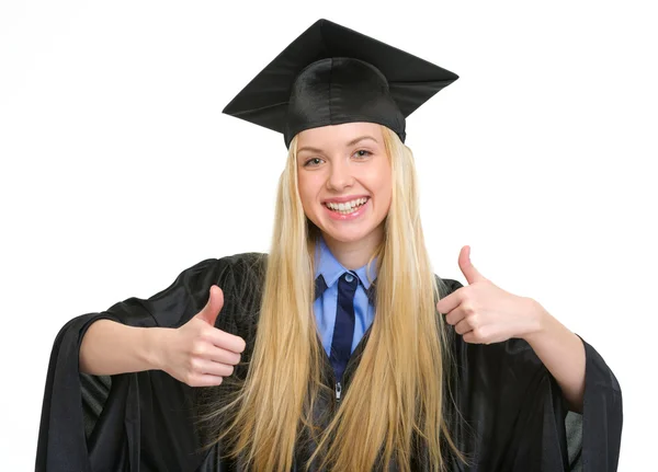 Felice giovane donna in abito di laurea mostrando pollici in su — Foto Stock