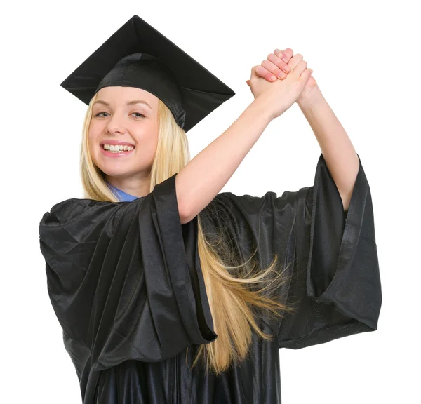 Sonriente joven en vestido de graduación regocijando el éxito — Foto de Stock