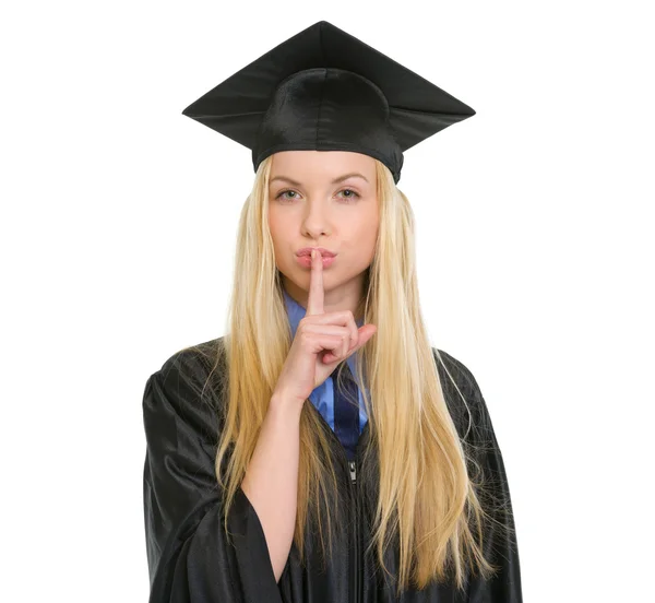 Mujer joven en vestido de graduación mostrando gesto shh — Foto de Stock