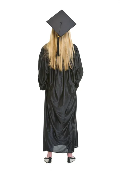 Full length portrait of woman in graduation gown . rear view — Stock Photo, Image