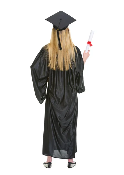 Full length portrait of woman in graduation gown showing diploma — Stock Photo, Image