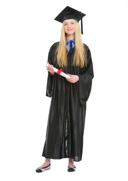 Full length portrait of happy young woman in graduation gown wit — Stock Photo, Image