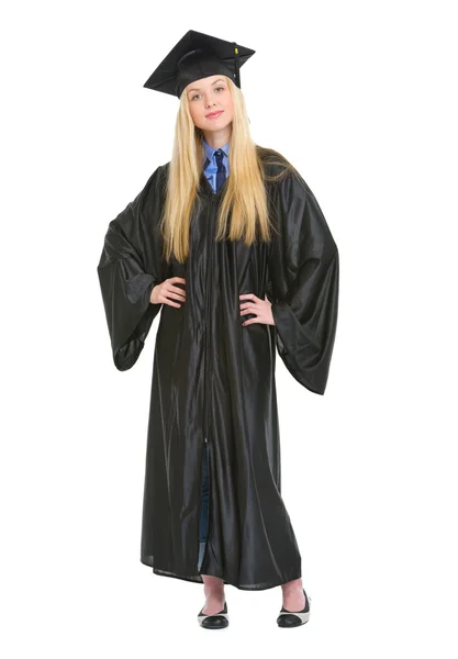 Full length portrait of happy young woman in graduation gown — Stock Photo, Image