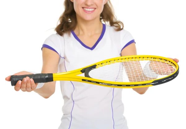 Closeup on smiling female tennis player giving racket — Stock Photo, Image