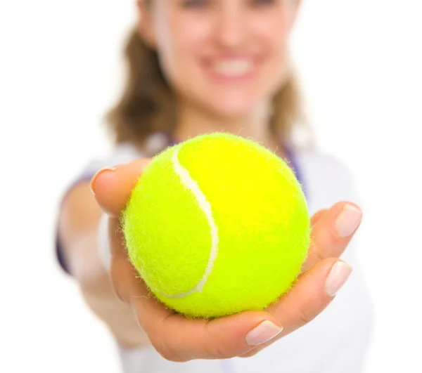 Closeup on ball in hand of happy female tennis player — Stock Photo, Image