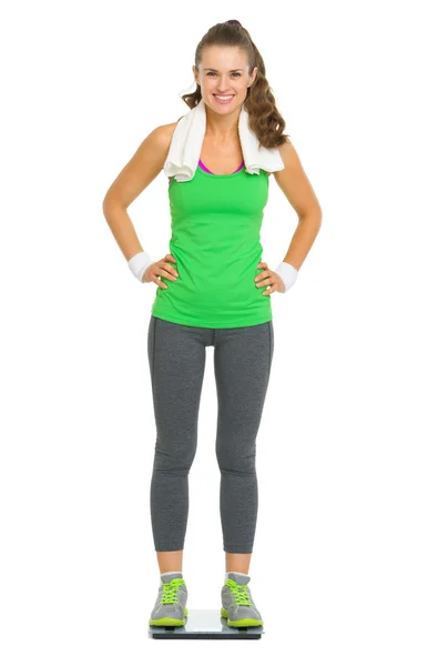Full length portrait of happy fitness young woman standing on sc — Stock Photo, Image