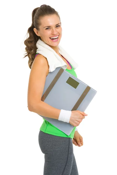 Portrait of smiling fitness young woman with scales — Stock Photo, Image