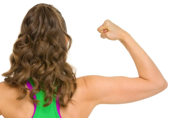 Fitness woman showing biceps . rear view — Stock Photo, Image