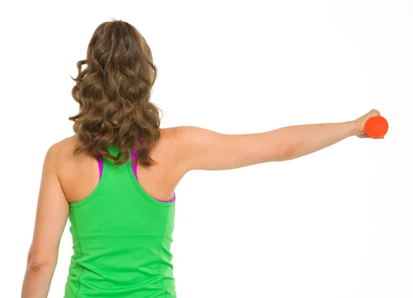 Healthy woman making exercise with dumbbells . rear view — Stock Photo, Image