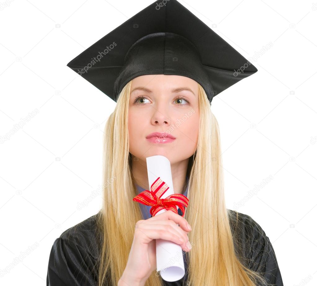 Portrait of thoughtful young woman in graduation gown with diplo