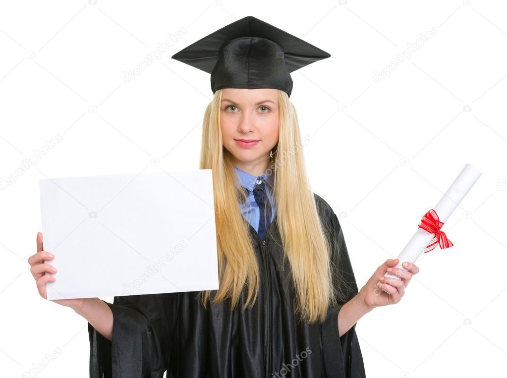Young woman in graduation gown with diploma showing blank billbo