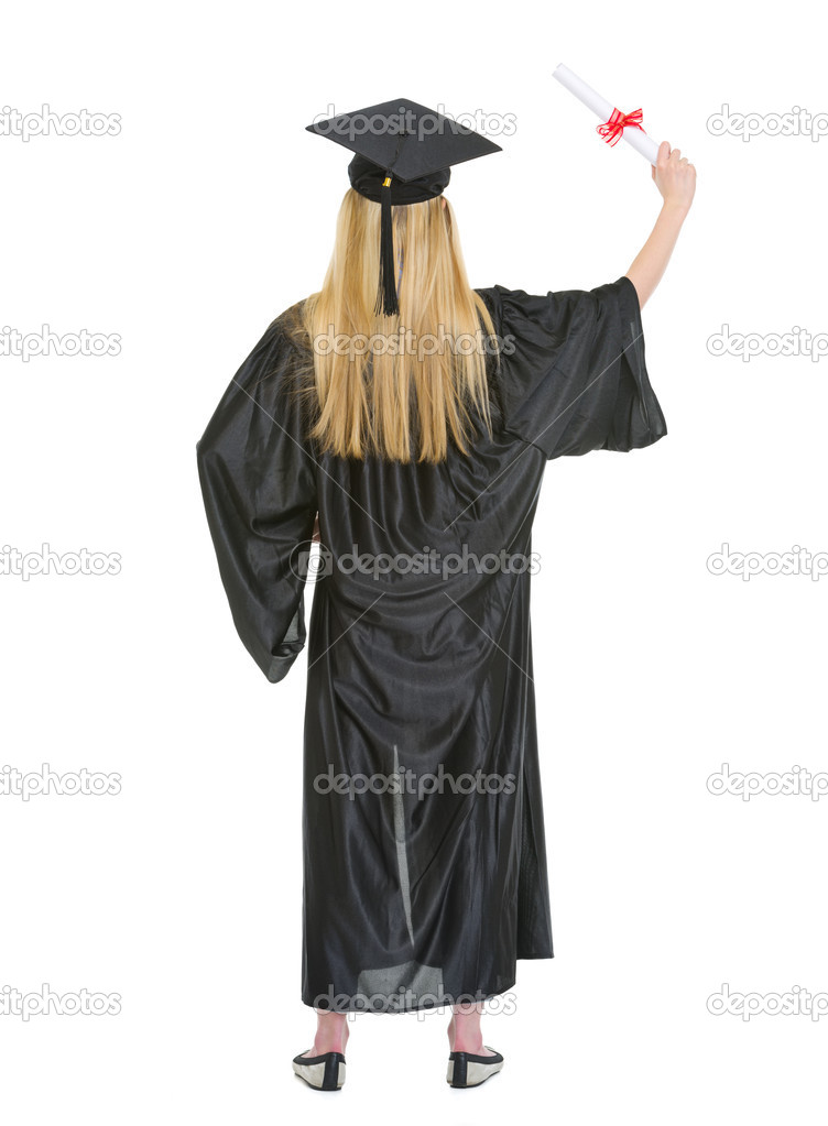 Full length portrait of young woman in graduation gown with dipl