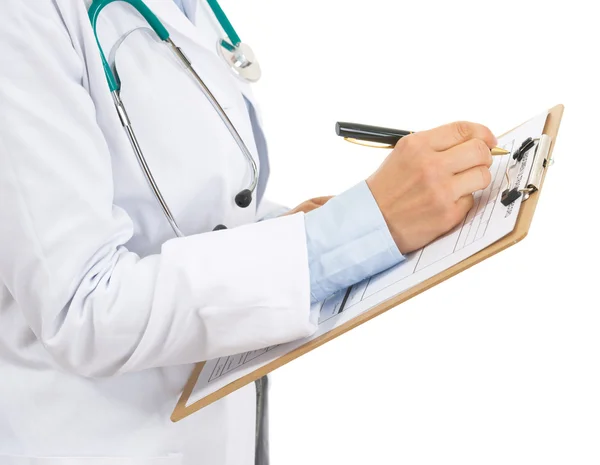 Closeup on doctor woman writing in clipboard — Stock Photo, Image