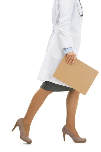 Closeup on doctor woman with clipboard going sideways — Stock Photo, Image