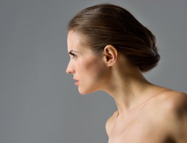 Beauty portrait of young woman isolated on gray background