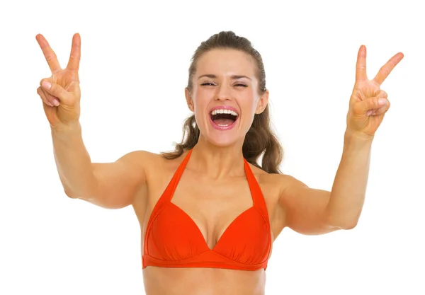Happy young woman in swimsuit showing victory gesture — Stock Photo, Image