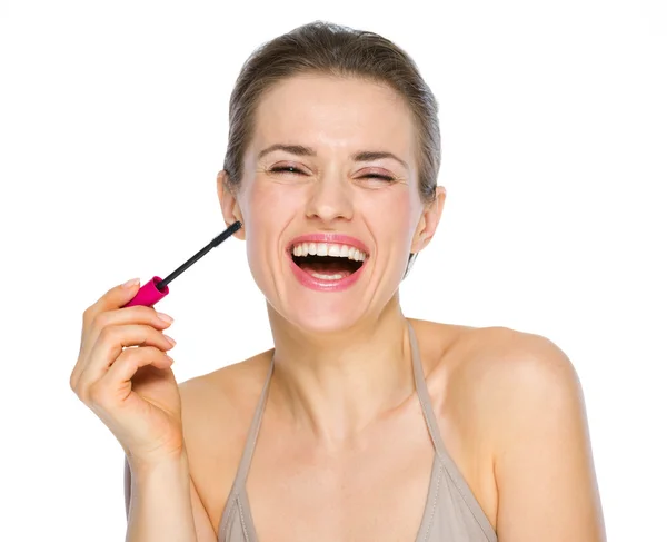 Beauty portrait of smiling young woman holding mascara brush — Stock Photo, Image
