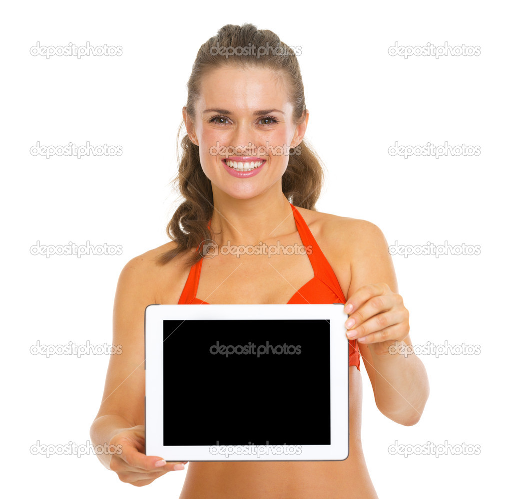 Smiling young woman in swimsuit showing tablet pc blank screen