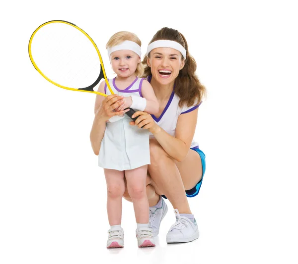 Portrait of happy mother and baby holding tennis racket — Stock Photo, Image