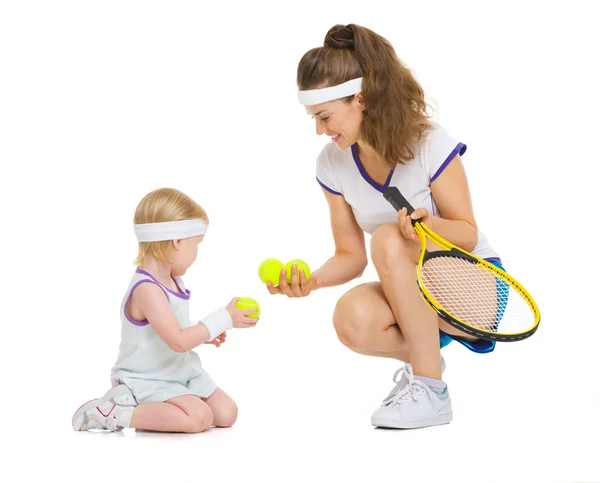 Mother and baby in tennis clothes playing — Stock Photo, Image