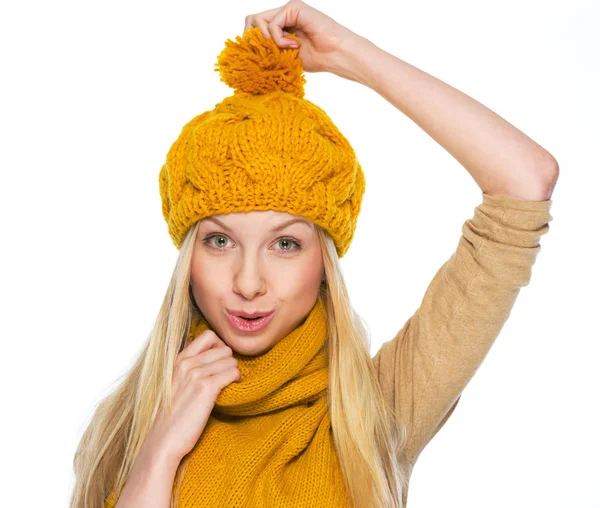 Happy girl holding took herself for hat — Stock Photo, Image