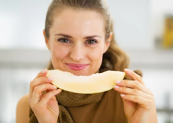 Happy young woman eating melon — Stock Photo, Image