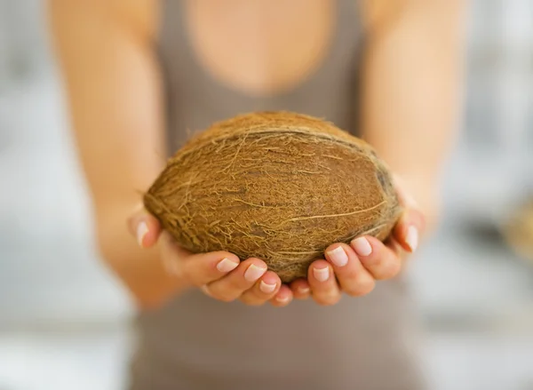 Closeup woman showing coconut — Stock Photo, Image