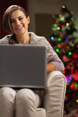 mutlu genç kadının yanına laptop ile Noel ağacı