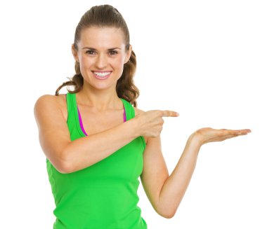gülümseyen fitness genç kadın bir şey boş avuç içinde sunulması