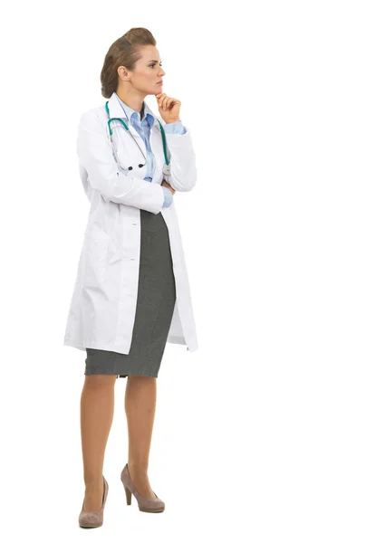 Full length portrait of thoughtful doctor woman looking on copy — Stock Photo, Image