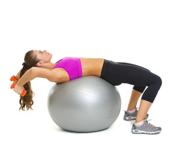 Fitness young woman making exercise with dumbbells on fitness ba — Stock Photo, Image