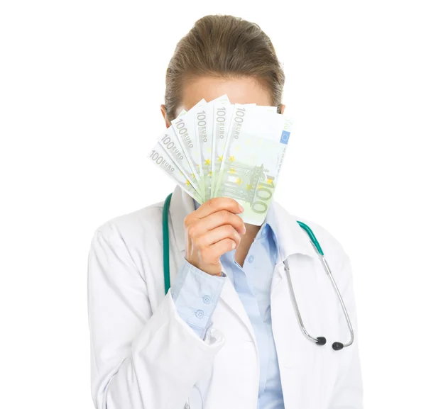 Doctor woman hiding behind fan of euros — Stock Photo, Image