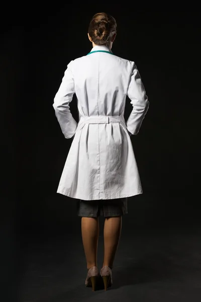 Full length portrait of doctor woman isolated on black. — Stock Photo, Image
