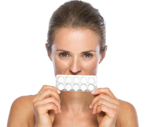 Young woman close mouth with pack of pills — Stock Photo, Image