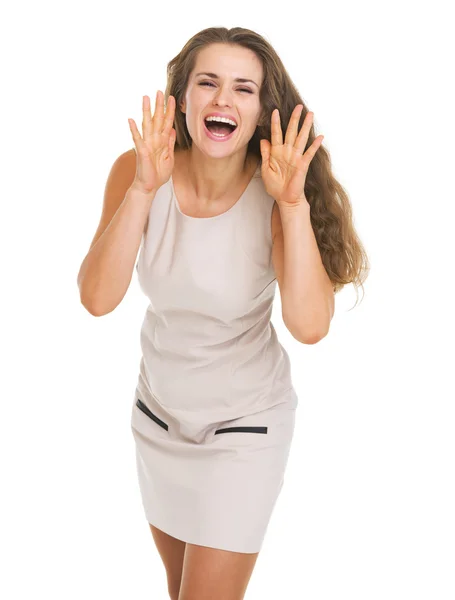 Happy young woman shouting through megaphone shaped hands — Stock Photo, Image