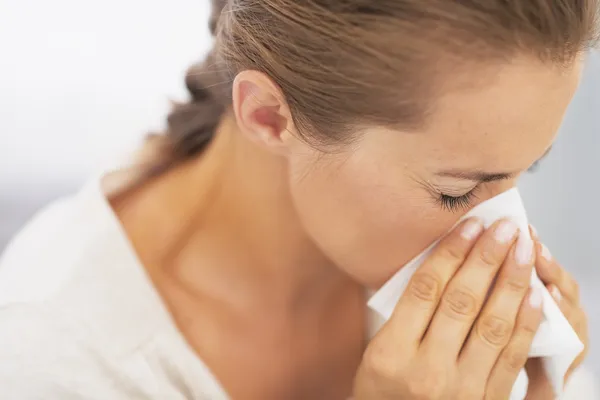 Woman blowing nose into handkerchief — Stock Photo, Image