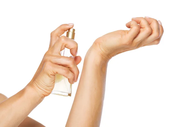 Closeup on woman applying perfume on hand Stock Photo