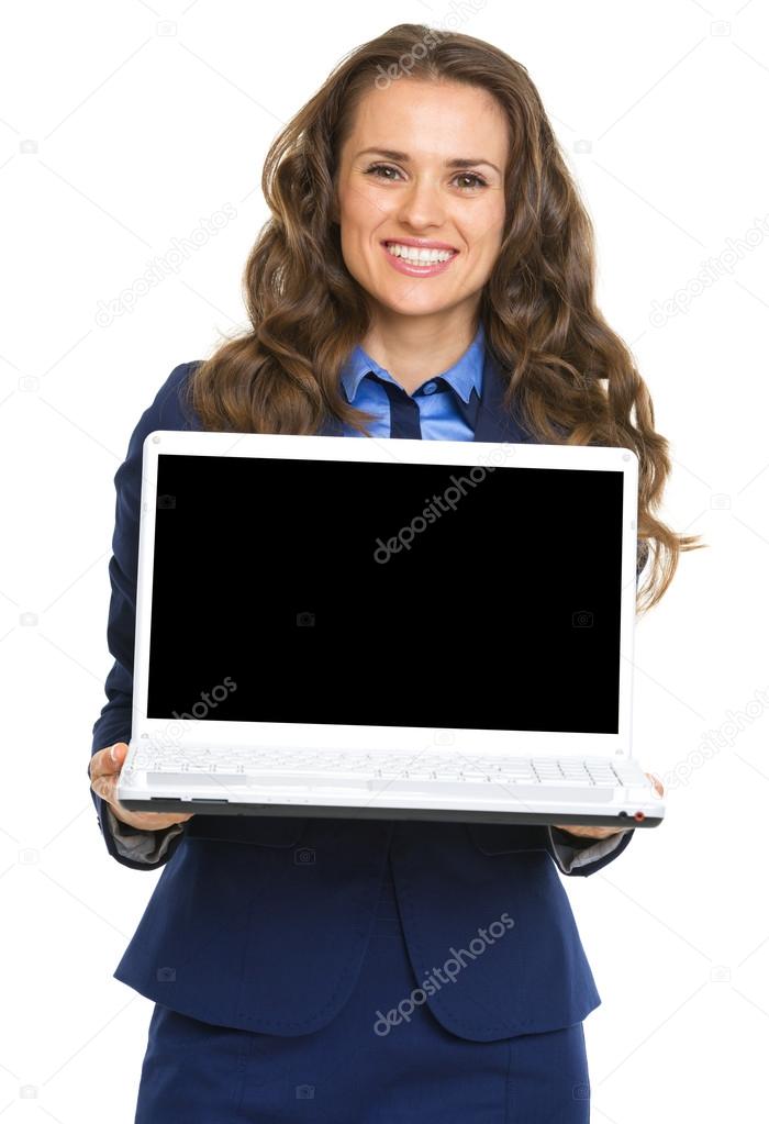 Smiling business woman showing laptop blank screen
