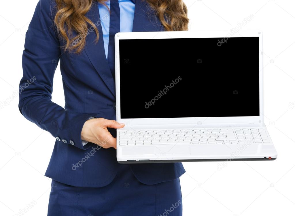 Closeup on business woman showing laptop blank screen