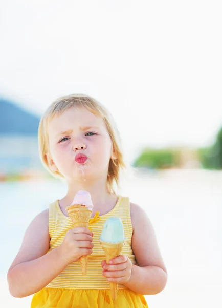 Happy baby enjoying two ice cream — Stock Photo, Image