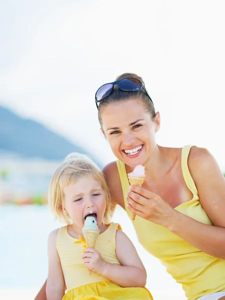 Smilende mor og baby spiser is - Stock-foto